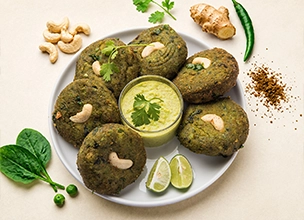 Hara Bhara Kababs garnished with cashews and served with mint chutney at Best Indian restaurant in Singapore. 